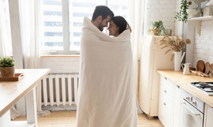 Mlad par se zavit v prešito odejo mucka v muhinji